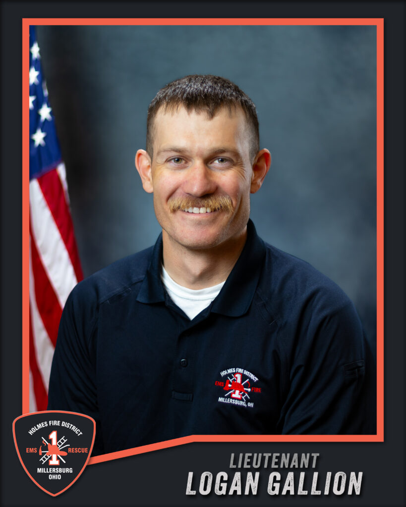 A man with short brown hair and a mustache, wearing a black polo shirt with a fire department logo, sits smiling in front of an American flag. Text reads: “Lieutenant Logan Gallion, Holmes Fire District, Millersburg Ohio.”.